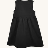 The back of the Eco Outfitters organic and fair trade cotton school pinafore dress in black.