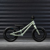 The side of the Early Rider Charger Balance Bike - Sage Green on a grey background
