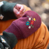 A closer look at the knitted gloves featuring a beautiful embroidered flower design on the back of the hand
