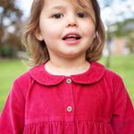 A closer look at the buttons and collar on the Frugi Coco Cord Dress - Lingonberry/Squirrel