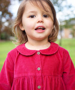 A closer look at the buttons and collar on the Frugi Coco Cord Dress - Lingonberry/Squirrel