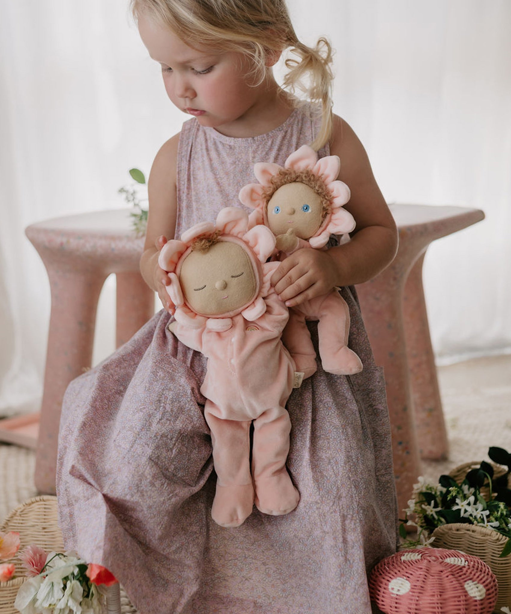 A child holding Olli Ella Limited Edition Tulip Dozy Dinkum - Talia Tulip & Dinky Dinkum Doll - Tessa Tulip in their arms
