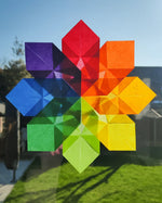 Kite Waxed Paper sunflower craft, an origami flower in rainbow Waldorf colours.