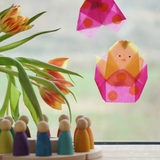 Kite Waxed Paper craft shaped as a chick in an Easter Egg, an origami spring craft in the Babipur playroom beside a Grapat perpetual calendar.