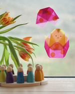 Kite Waxed Paper craft shaped as a chick in an Easter Egg, an origami spring craft in the Babipur playroom beside a Grapat perpetual calendar.