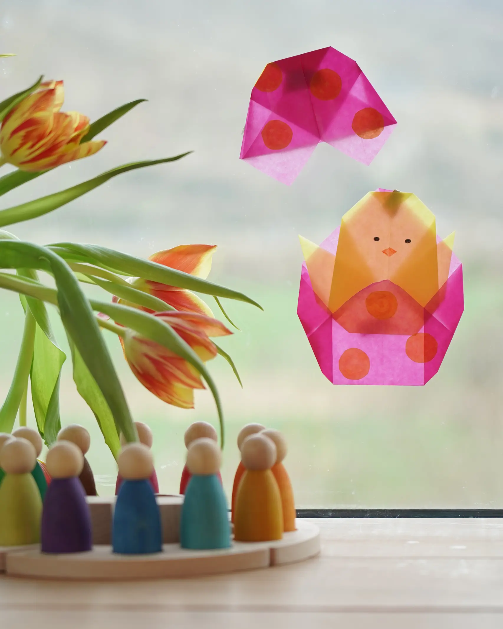 Kite Waxed Paper craft shaped as a chick in an Easter Egg, an origami spring craft in the Babipur playroom beside a Grapat perpetual calendar.