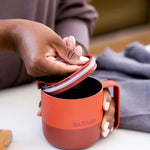 A person taking off the Klean Kanteen Rise Flip Lid off A Rise Tumbler Mug
