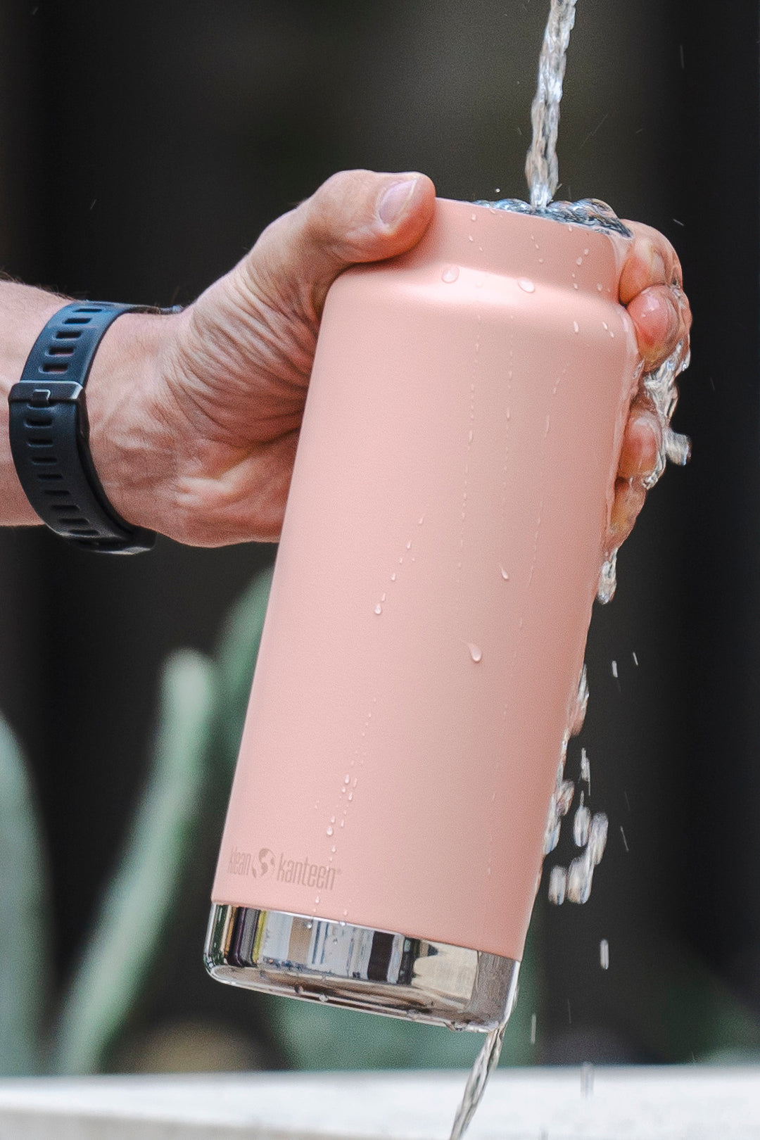 Kean Kanteen TK wide water bottle/coffee flask in use with water running into it, flask is pink - image to represent Klean Kanteen SALE at babipur this Spring
