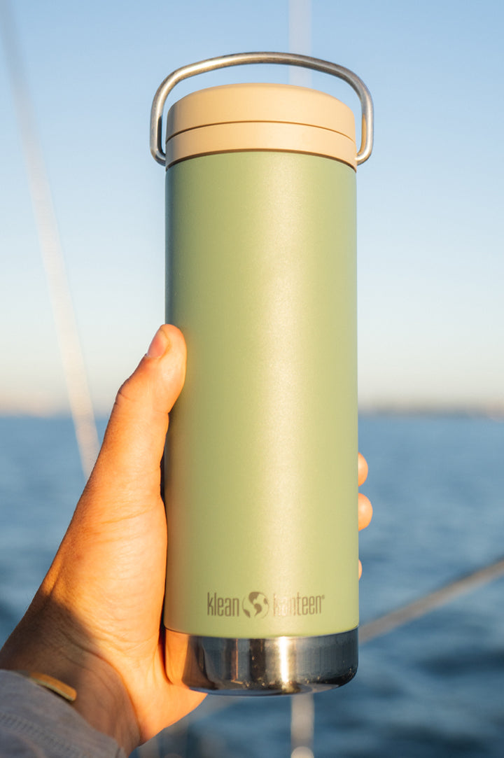 Klean Kanteen TKWide Reusable Insulated Bottle in sea spray green in a hand to represent our range of stainless steel TKWides at Babipur.