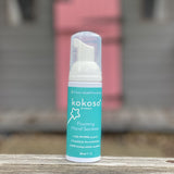 Kokoso protect foaming hand sanitiser original 50ml bottle standing on a wooden surface. Bottle available at Babipur 