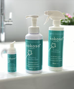 The Kokoso protect range standing on the side of the bath including the 500ml and 50ml foaming hand sanitiser and surface disinfectant, all available at Babipur