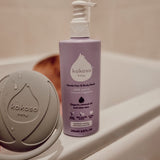 Kokoso 200m softly coconut scented organic baby body and hair wash standing on the side of the bath. Bottle available at Babipur. 