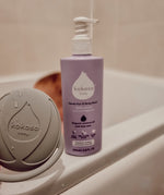 Kokoso 200m softly coconut scented organic baby body and hair wash standing on the side of the bath. Bottle available at Babipur. 
