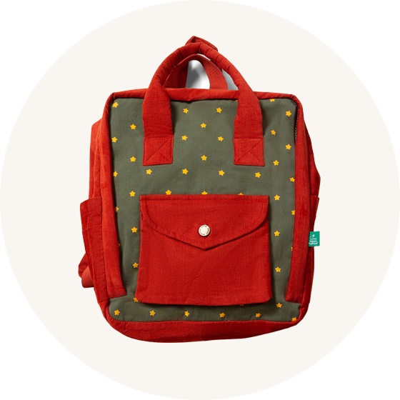 Little Green Radicals Kids Backpack - Ready For Adventure / Yellow Stars - Fairtrade and GOTS organic twill cotton with two red side pockets, handles and straps, a khaki front with star print and a red envelope pocket.