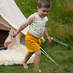 A child wearing the Adventure Print vest top, from the LGR Adventure Organic Vest Set - 3 Pack