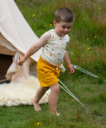 A child wearing the Adventure Print vest top, from the LGR Adventure Organic Vest Set - 3 Pack