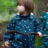 A child outside, wearing the LGR Starry Night Waterproof Winter Suit