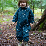 A child playing in the forest, wearing the LGR Starry Night Waterproof Winter Suit