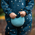 A closer view of the LGR Starry Night Waterproof Winter Suit, with a child holding a light blue LGR moon cushion