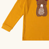 Close up of the front of the Little Green Radicals gold bear applique organic cotton long sleeve childrens top.