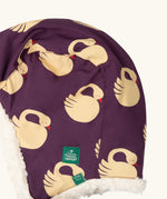 Close up of Little Green Radicals  sleeping swans print sherpa fleece lined purple hat. Purple organic cotton sherpa fleece lined flapper style hat with a sleeping swans print. 