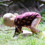 A young child on all fours on grass wearing a Little Green Radicals Baby Bodysuit 2 Pack featuring a Brown Bears print. Little Green Radicals offer a range of organic cotton children's clothing available here at Babipur. 