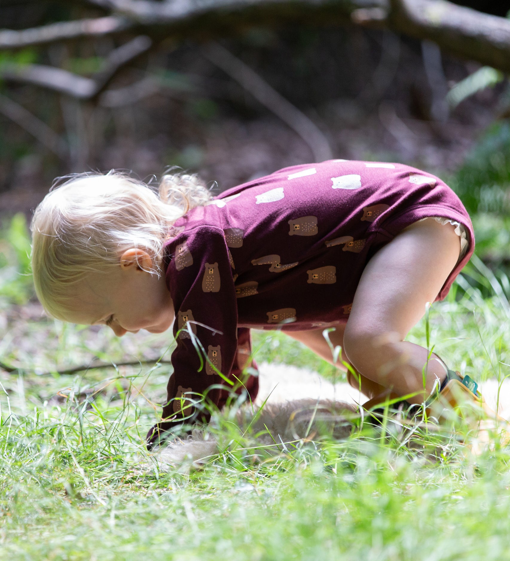 A young child on all fours on grass wearing a Little Green Radicals Baby Bodysuit 2 Pack featuring a Brown Bears print. Little Green Radicals offer a range of organic cotton children's clothing available here at Babipur. 