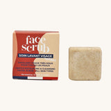Lamazuna Solid Face Scrub Bar, gentle exfoliating and cleansing scrub bar for all skin types, next to its cardboard packaging on a cream background
