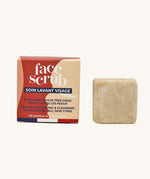 Lamazuna Solid Face Scrub Bar, gentle exfoliating and cleansing scrub bar for all skin types, next to its cardboard packaging on a cream background