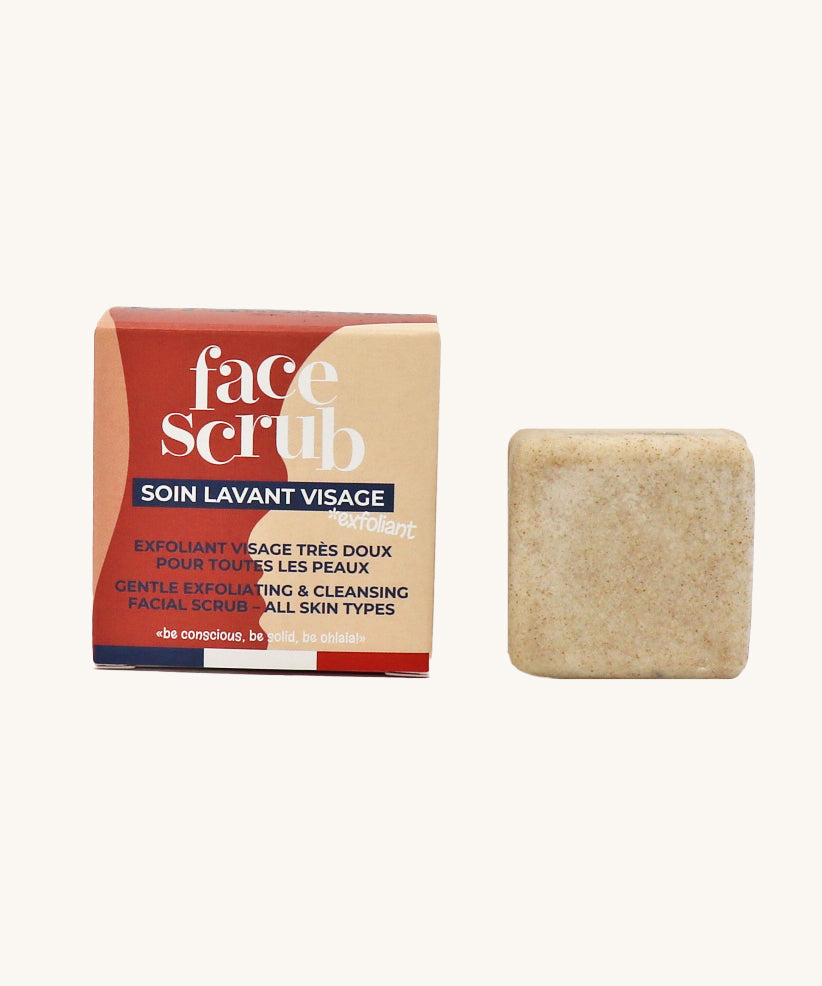 Lamazuna Solid Face Scrub Bar, gentle exfoliating and cleansing scrub bar for all skin types, next to its cardboard packaging on a cream background