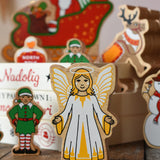 Lanka Kade Christmas angel toy in yellow and white next to a Christmas eve box filled with Lanka Kade figures.