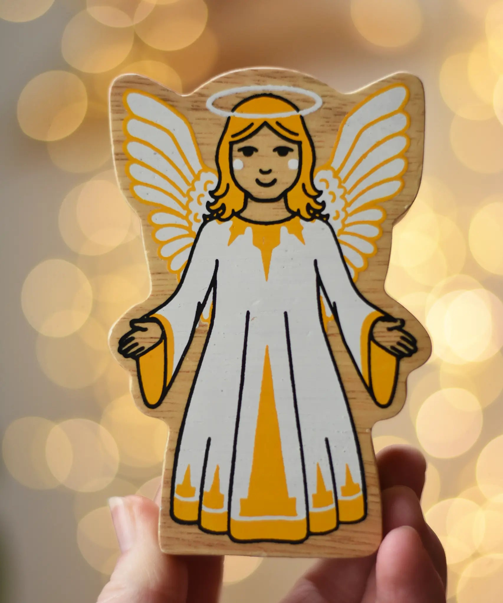 Lanka Kade angel with white and yellow dress, halo and wings, a kids Christmas wooden toy.