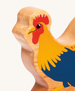 A close up of the chunky wooden Lanka Kade blue cockerel wooden figure available at Babipur.