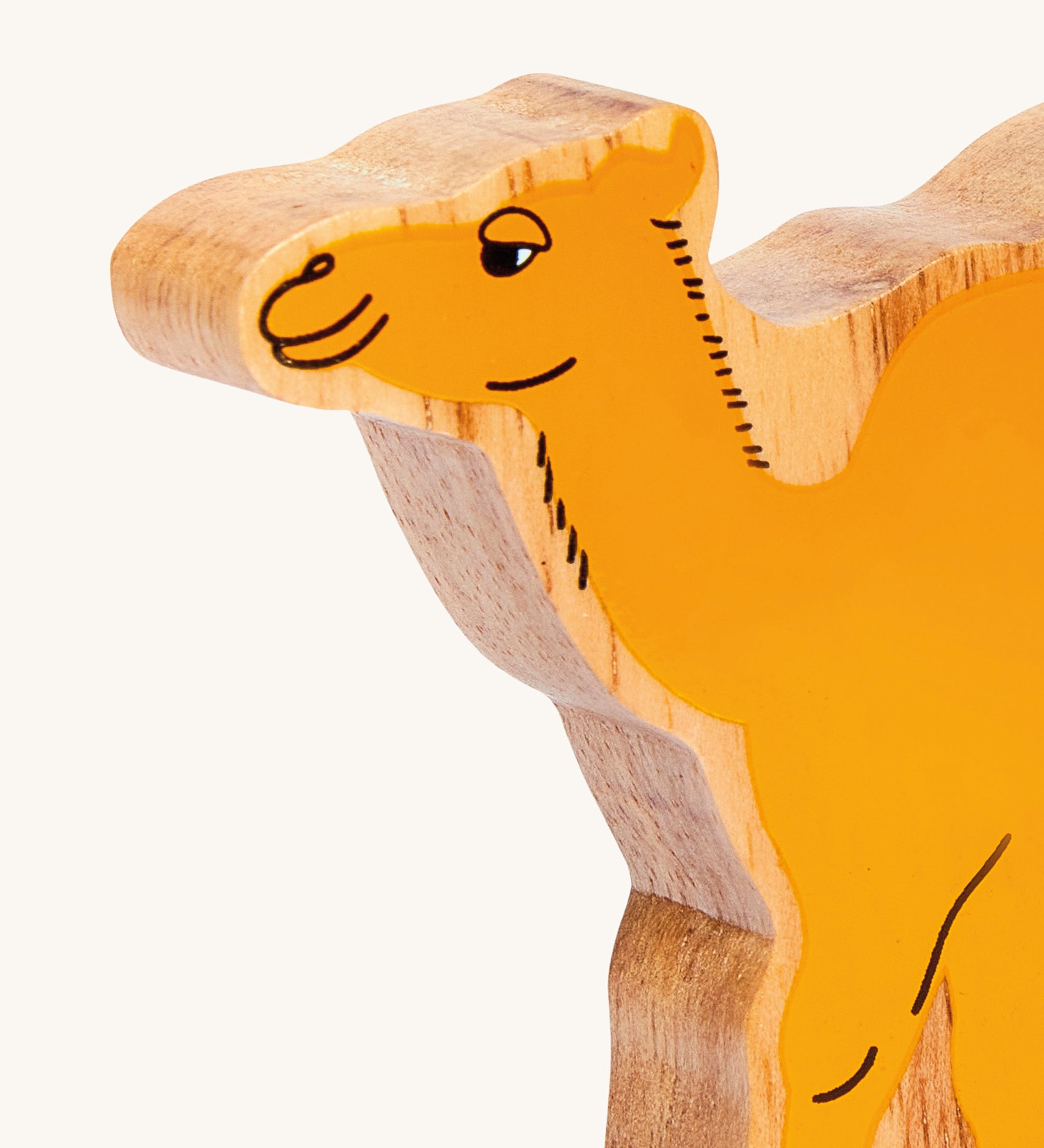 A close up of the chunky wooden Lanka Kade yellow camel figure available at Babipur. 