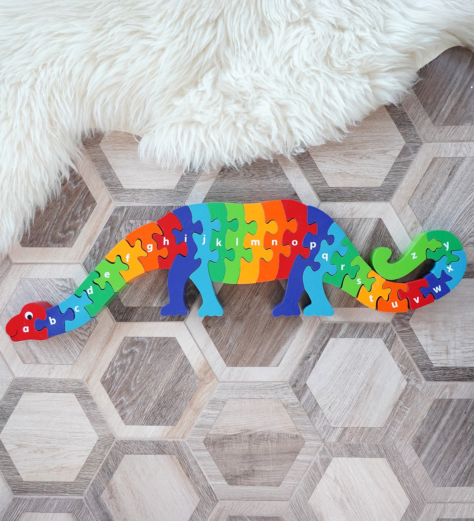 Lanka Kade Dizzie The Dinosaur A-Z Jigsaw, a chunky 26 piece kids wooden alphabet jigsaw in rainbow colours, for sale at Babipur.