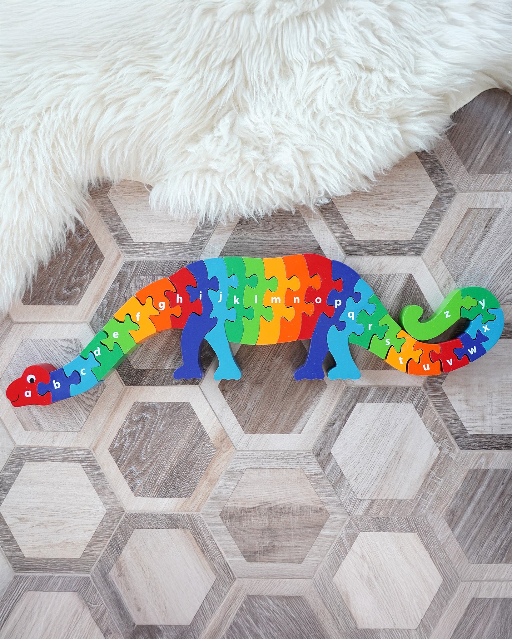 Lanka Kade Dizzie The Dinosaur A-Z Jigsaw, a chunky 26 piece kids wooden alphabet jigsaw in rainbow colours, for sale at Babipur.