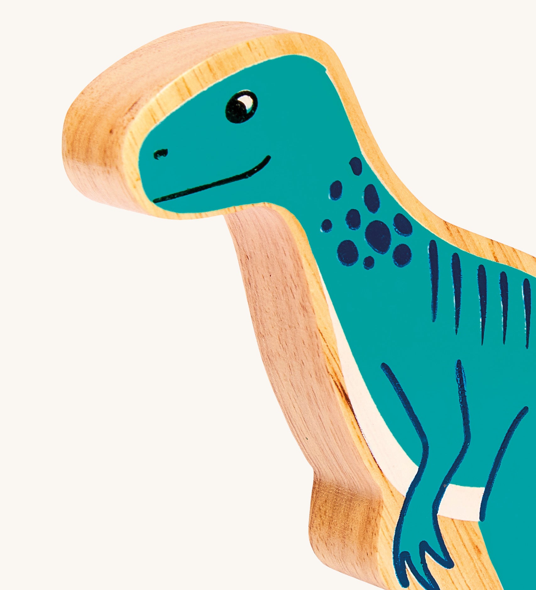 A close up of the chunky wooden Lanka Kade Green Eotyrannus dinosaur figure available at Babipur.