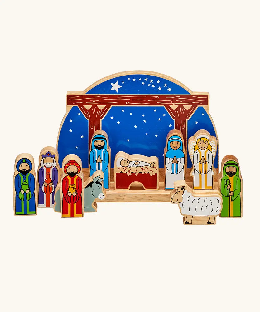 Lanka Kade wooden Nativity scene toy set featuring colorful painted wooden figures of animals and biblical characters, arranged in front of a wooden stable.