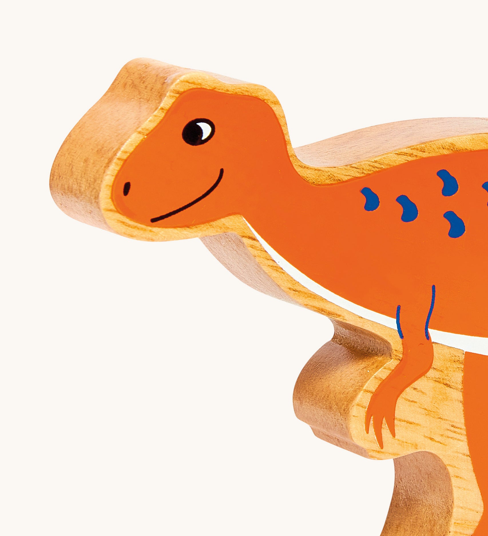 A close up of the chunky wooden Lanka Kade orange Hysilophodon dinosaur figure available at Babipur.