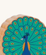 A close up of the chunky wooden Lanka Kade figure of a standing peacock and available at Babipur.