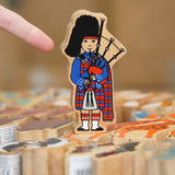 Lanka Kade Wooden Scottish Bagpiper toy in a kilt in the Babipur Warehouse.