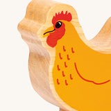 A close up of the A chunky wooden Lanka Kade orange standing hen figure available at Babipur showing the painted face detail