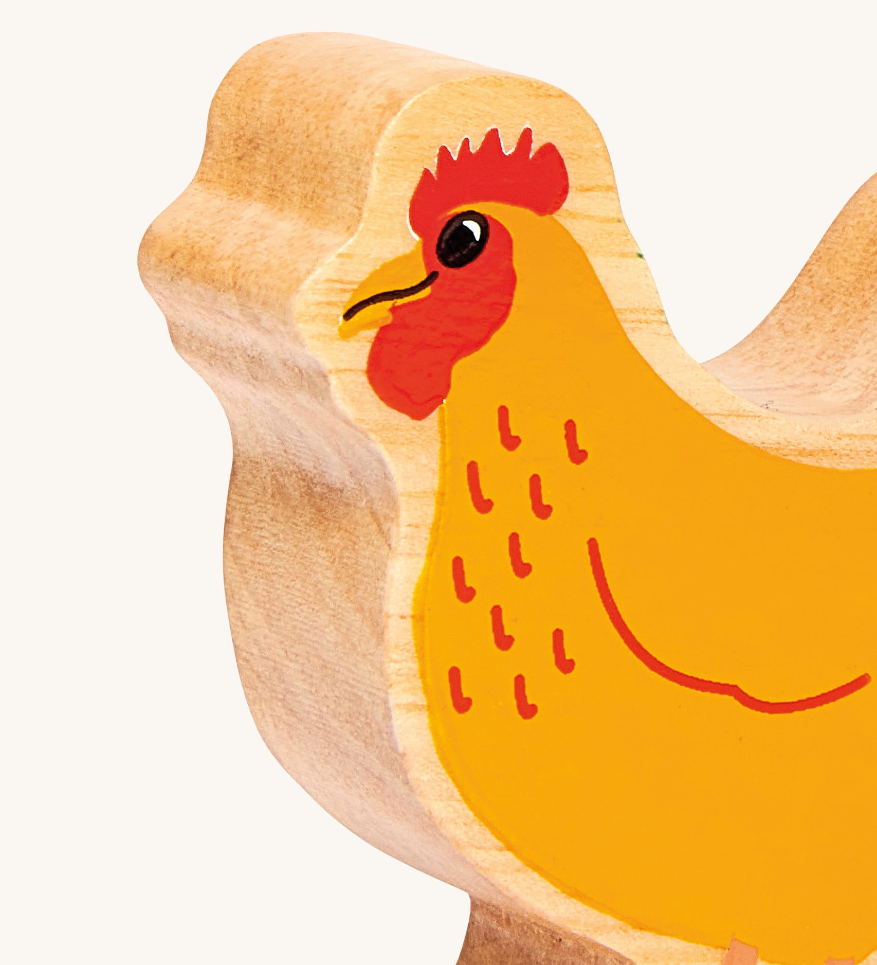 A close up of the A chunky wooden Lanka Kade orange standing hen figure available at Babipur showing the painted face detail
