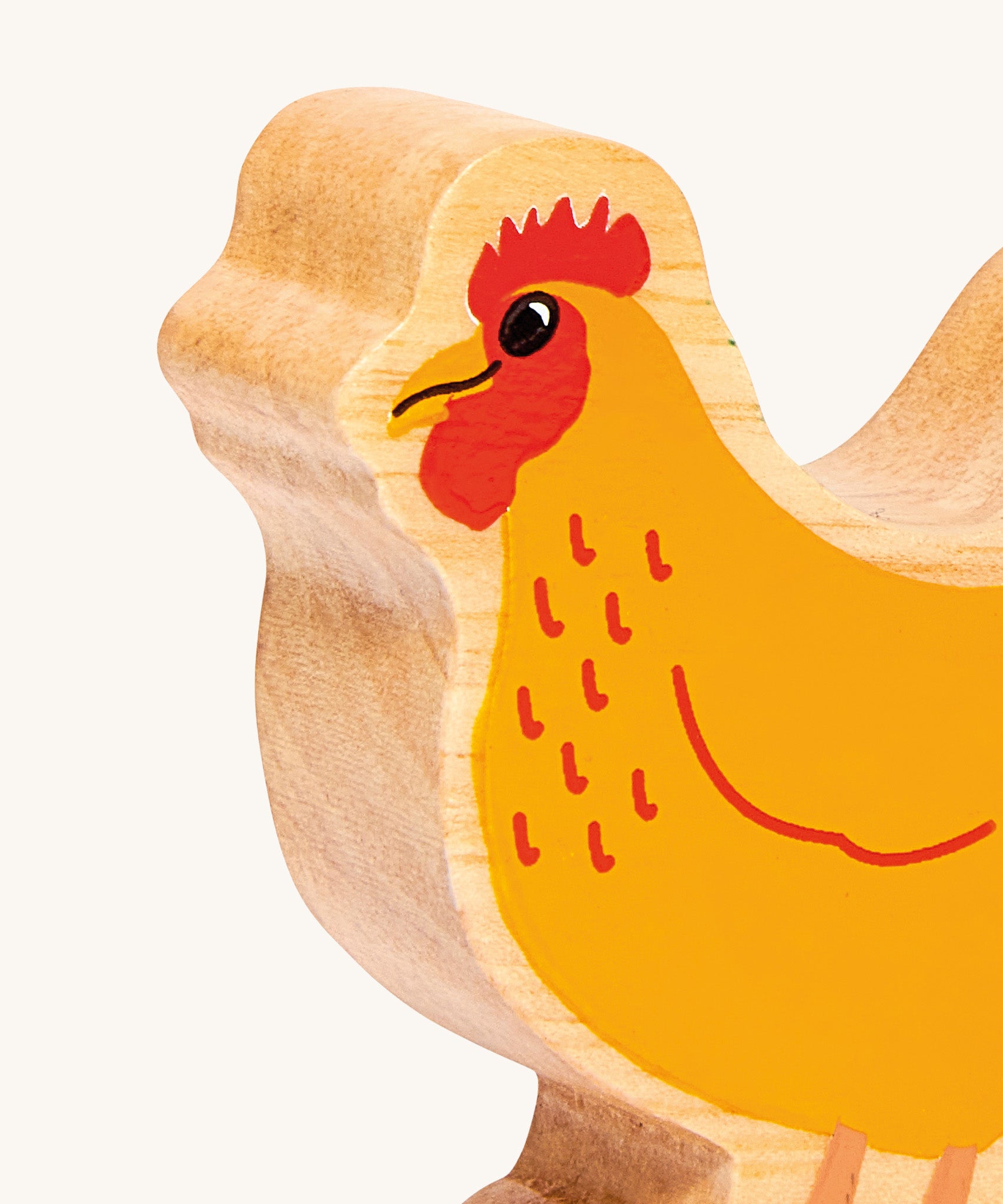 A close up of the A chunky wooden Lanka Kade orange standing hen figure available at Babipur showing the painted face detail