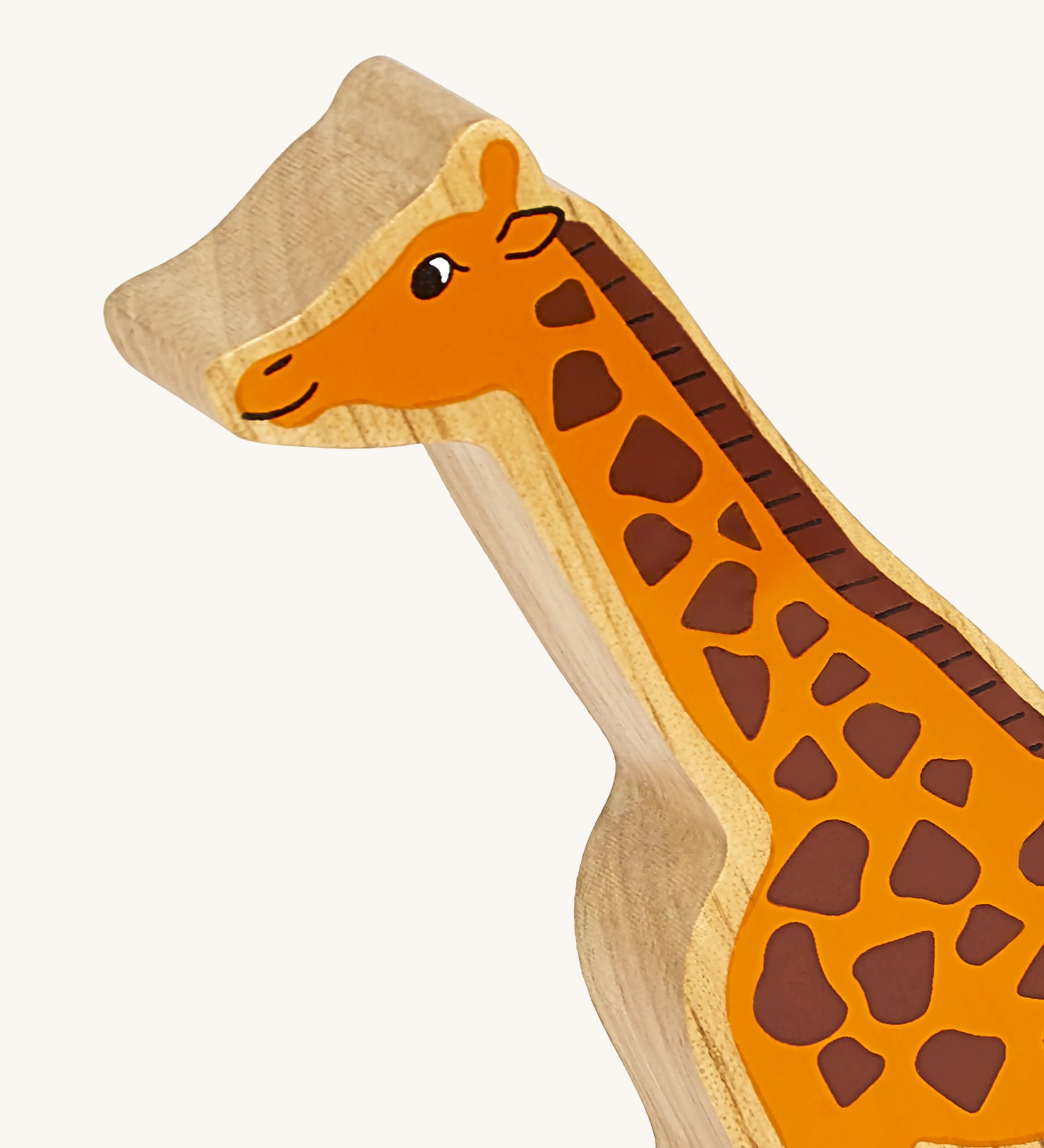 A close up of the chunky wooden Lanka Kade orange giraffe animal figure available at Babipur showing its facial features