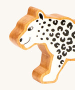 A close up of the chunky wooden Lanka Kade white snow leopard animal figure available at Babipur.