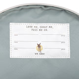 The inside of the Lassig kids tiny Dino backpack, showing the name label that has multiple spaces for when the bag is passed on to younger kids. 