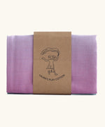 Laura's play cotton pastel rainbow extra large play cloth made from 100% organic cotton held by a decorated cardboard strip