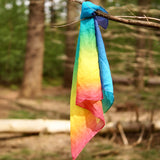 Laura's play cotton bright rainbow play cloth made from 100% organic cotton hanging on a branch