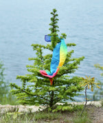 Laura's play cotton bright rainbow play cloths made from organic cotton tied onto a fir tree